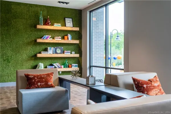 a living room with furniture and floor to ceiling windows
