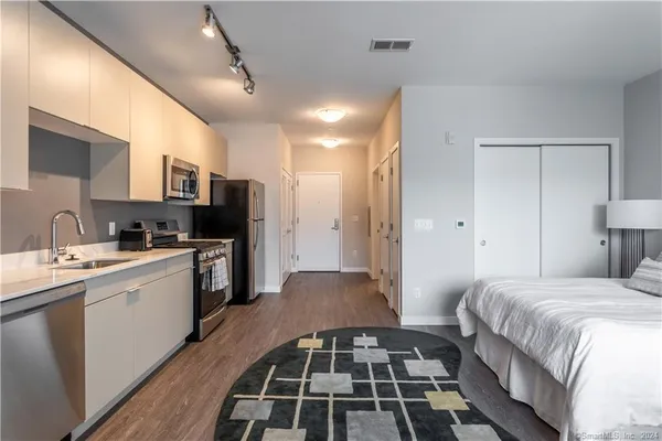 a kitchen with stainless steel appliances granite countertop a sink and a cabinets