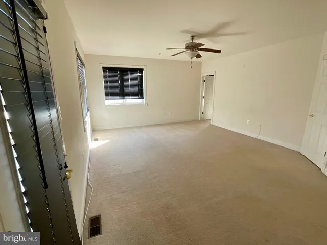 en empty room with a fireplace and a chandelier