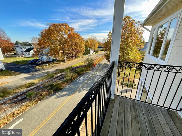 a view of a balcony with wooden floor
