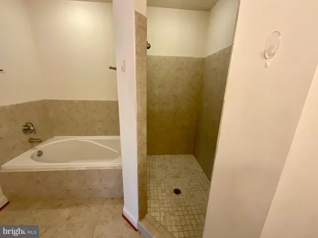 a bathroom with a tub and shower
