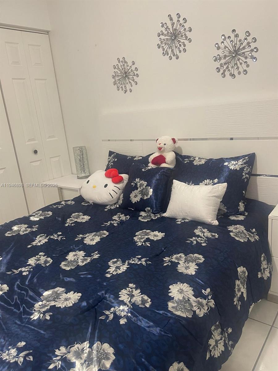 600 Southeast 25th Lane Homestead, FL 33033 - Photo 12 of 25 a bed sitting in a bedroom and dresser