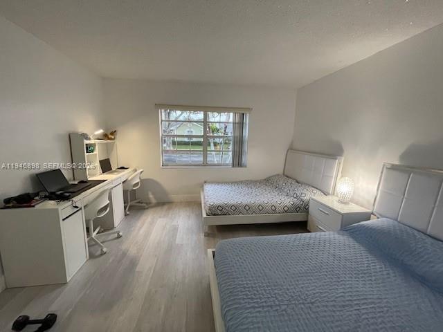 600 Southeast 25th Lane Homestead, FL 33033 - Photo 9 of 25 a bedroom with a bed and a night stand
