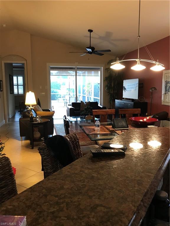 19768 Tesoro Way Estero, FL 33967 - Photo 2 of 5 a living room with fireplace furniture and a large window