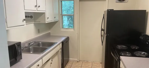 a kitchen with a refrigerator and a stove