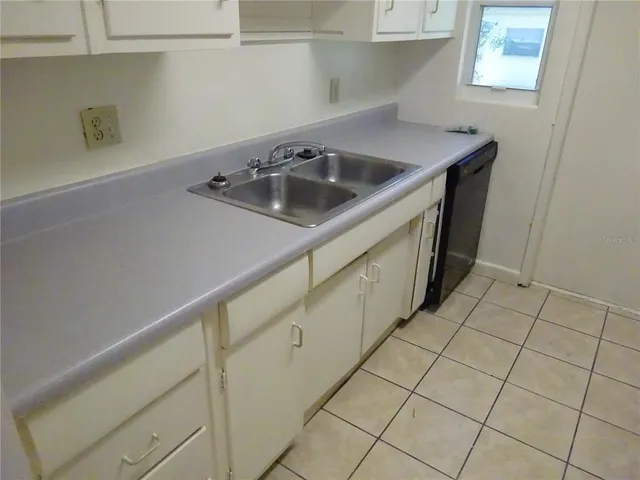 a kitchen with a sink and cabinets