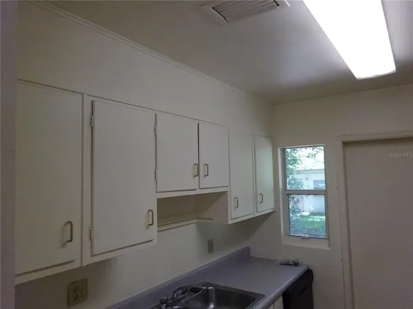 a room with cabinets and window
