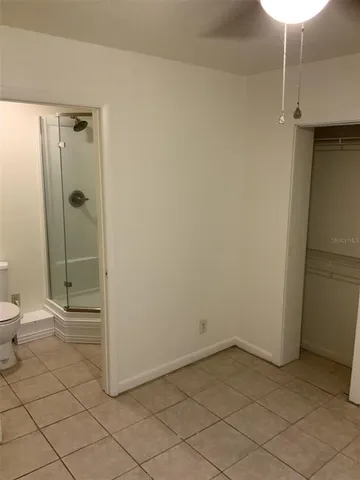 a bathroom with a shower and a toilet