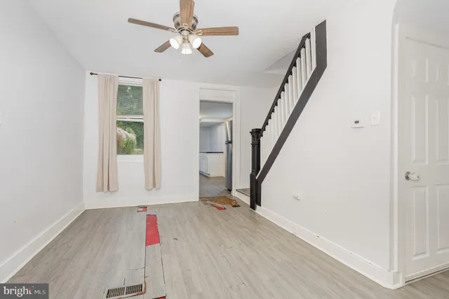 wooden floor in an empty room with a window