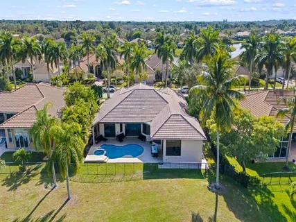 an aerial view of a house with swimming pool garden and patio