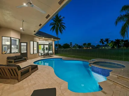 an aerial view of residential houses with outdoor space and swimming pool