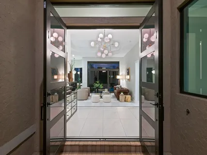 a view of a dining room with furniture and a chandelier