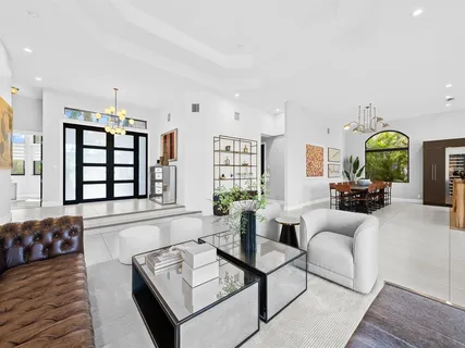 a living room with fireplace furniture and floor to ceiling window