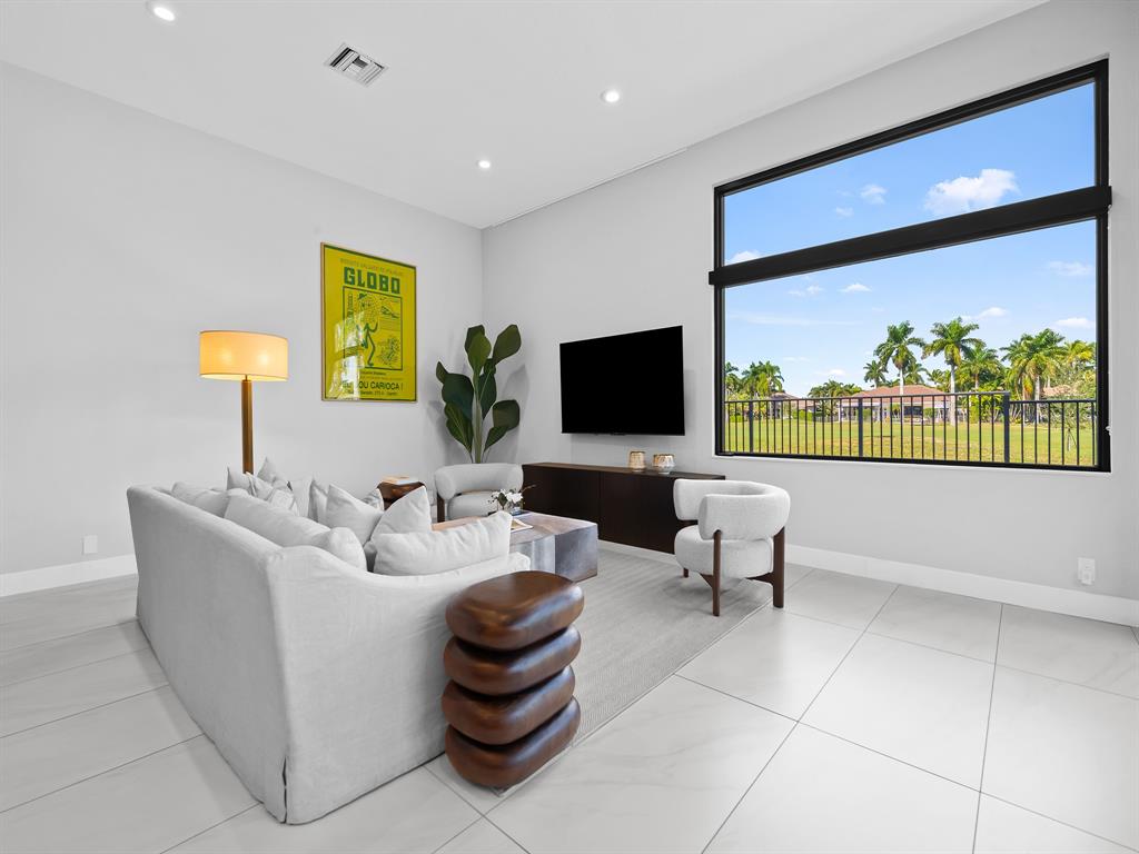 2583 Mayfair Lane Weston, FL 33327 - Photo 26 of 61 a living room with furniture and a flat screen tv