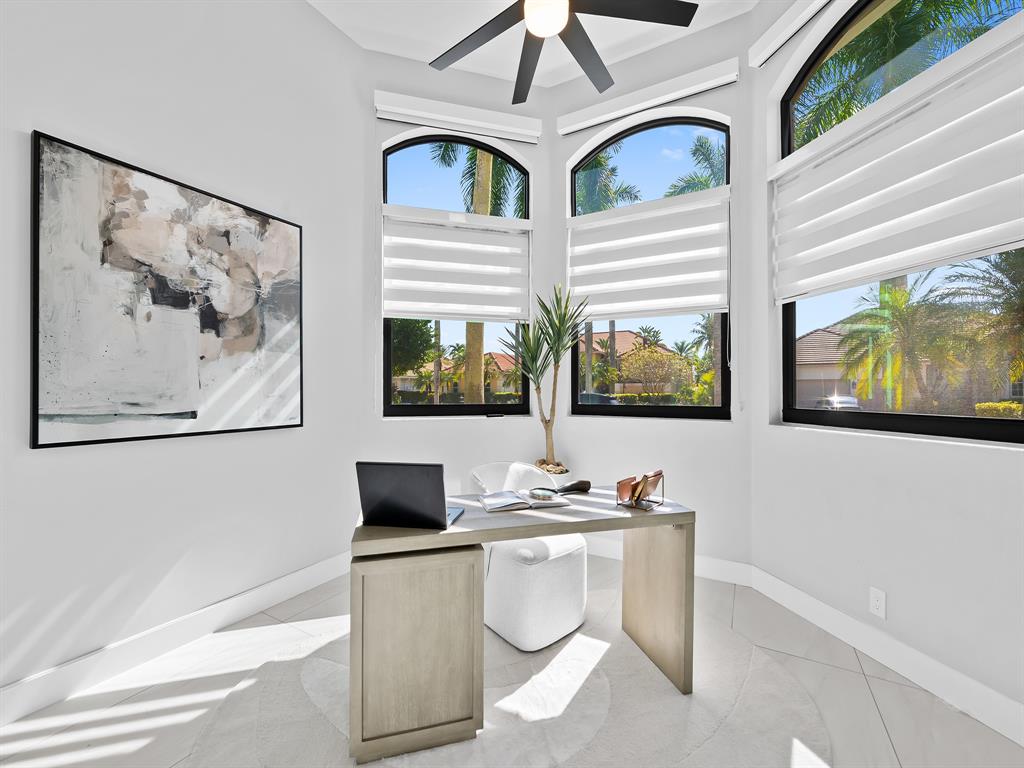 2583 Mayfair Lane Weston, FL 33327 - Photo 32 of 61 a living room with couches and a painting on the wall