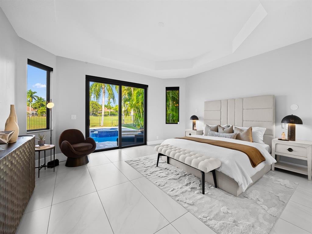 2583 Mayfair Lane Weston, FL 33327 - Photo 34 of 61 a bedroom with a bed and a large window