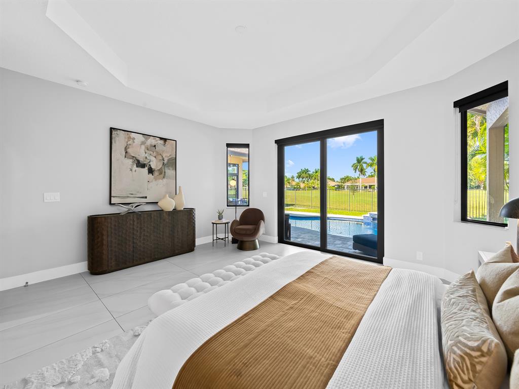 2583 Mayfair Lane Weston, FL 33327 - Photo 35 of 61 a bedroom with a large bed and a large window