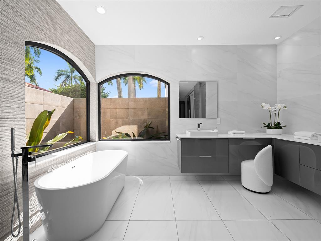 2583 Mayfair Lane Weston, FL 33327 - Photo 38 of 61 a bathroom with a tub a sink and mirror