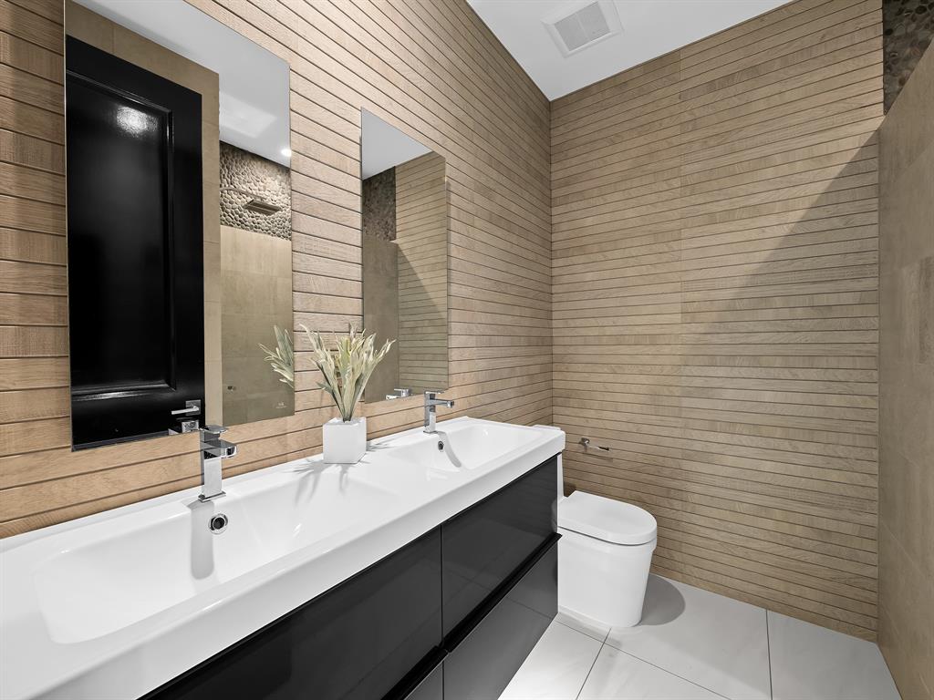 2583 Mayfair Lane Weston, FL 33327 - Photo 39 of 61 a bathroom with a sink a toilet and mirror