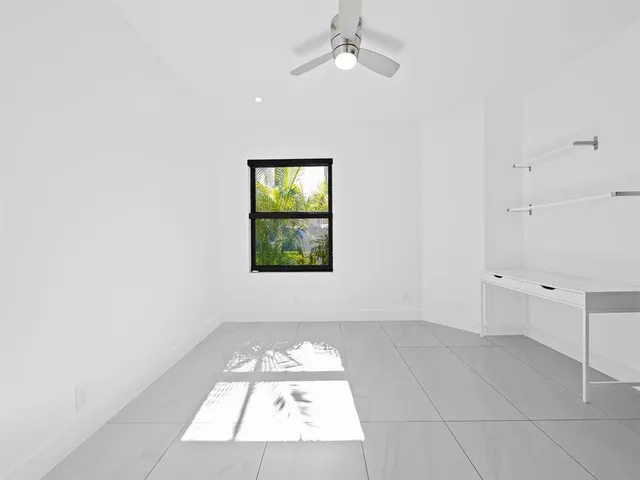 a view of swimming pool with a table and chairs under an umbrella