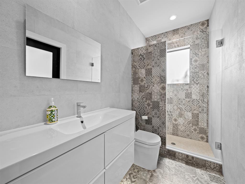 2583 Mayfair Lane Weston, FL 33327 - Photo 45 of 61 a bathroom with a sink a toilet and shower