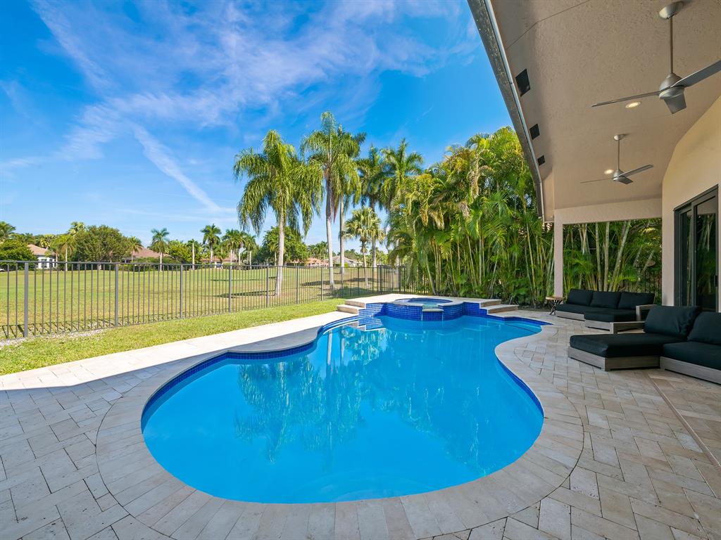2583 Mayfair Lane Weston, FL 33327 - Photo 55 of 61 a view of a swimming pool with an outdoor space and seating area