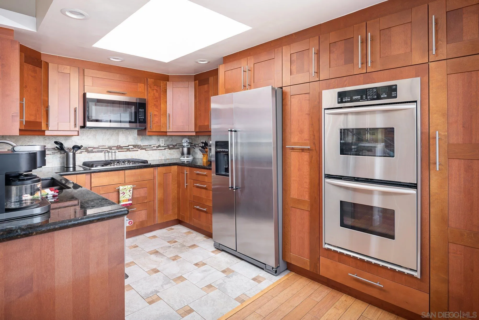 4361 Valle Drive La Mesa, CA 91941 - Photo 19 of 67 a kitchen with stainless steel appliances granite countertop a refrigerator stove and sink