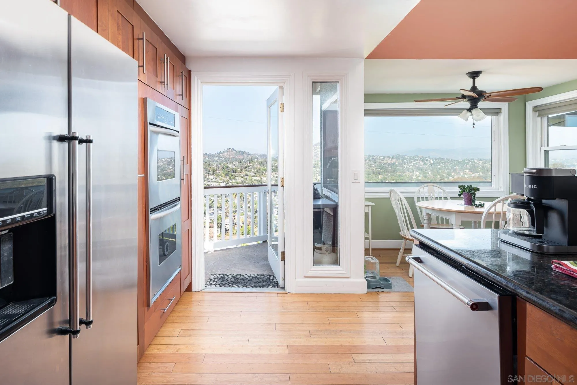 4361 Valle Drive La Mesa, CA 91941 - Photo 21 of 67 a kitchen with stainless steel appliances granite countertop a refrigerator a stove and a sink with wooden floor