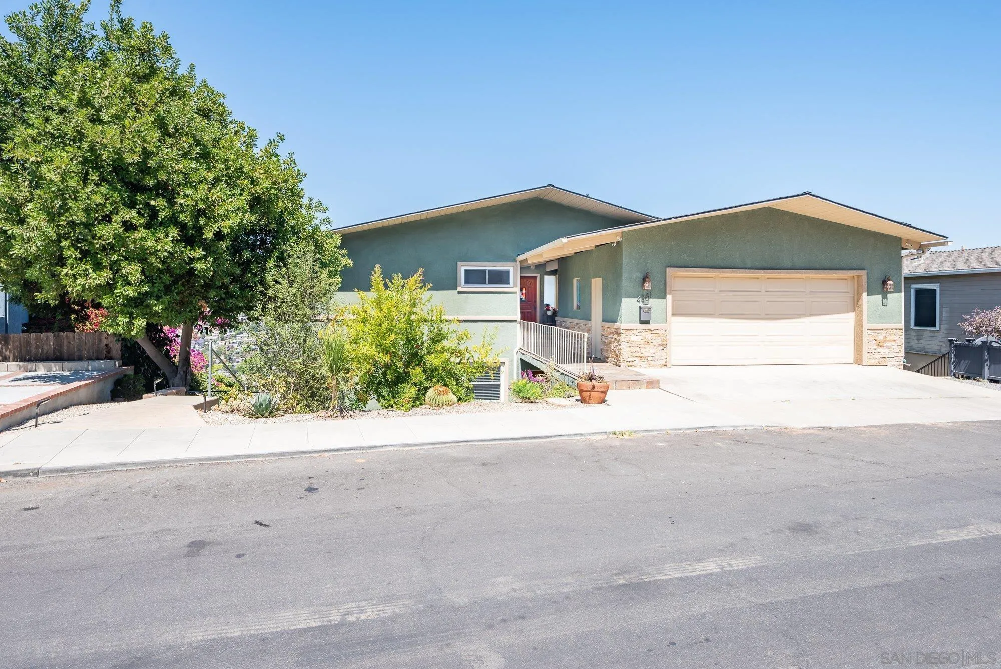 4361 Valle Drive La Mesa, CA 91941 - Photo 8 of 67 a front view of a house with a yard and garage