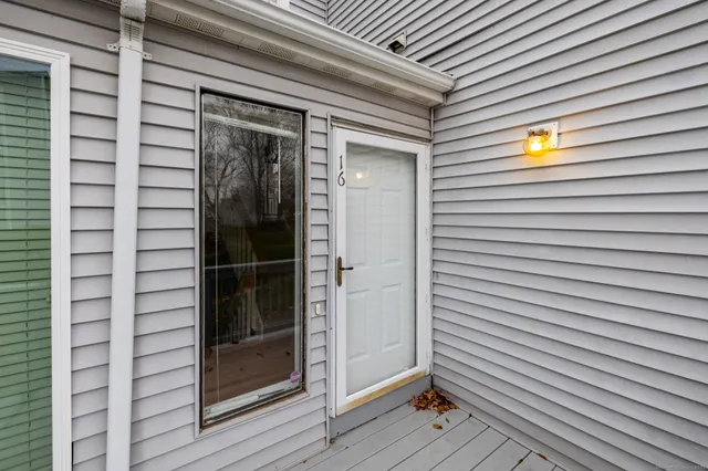 a view of a porch with a door and wooden floor