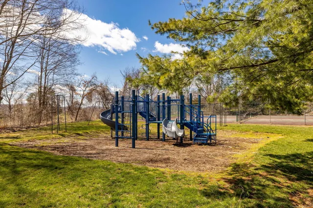 a view of a park with swings and slides