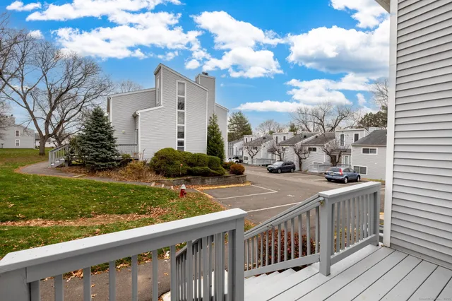 a view of a house with a wooden fence