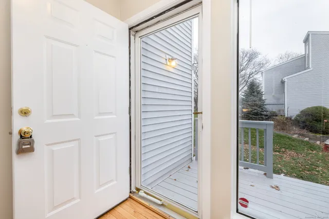 a view of a door and chair in front of a door