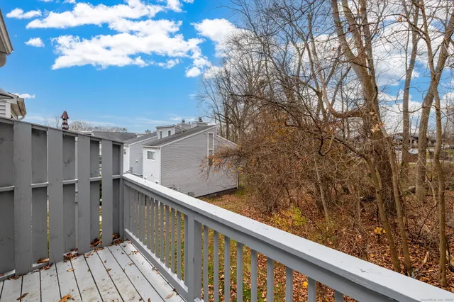 a view of a balcony with wooden fence