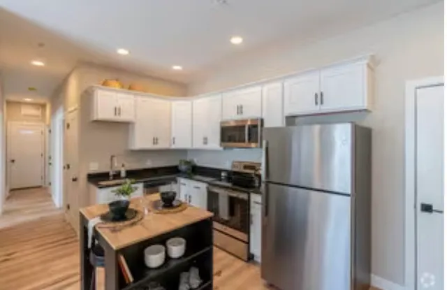 a kitchen with a refrigerator a stove a sink and a refrigerator