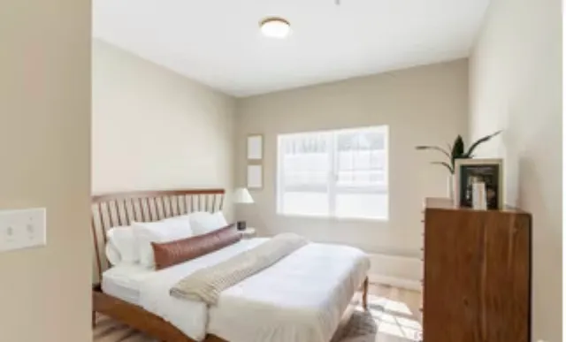 a bedroom with a bed and a couch