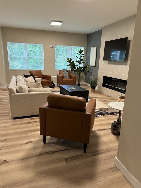 23 Prentice Street, Unit 2205 Grafton, MA 01536 - Photo 6 of 8 a living room with furniture and a flat screen tv