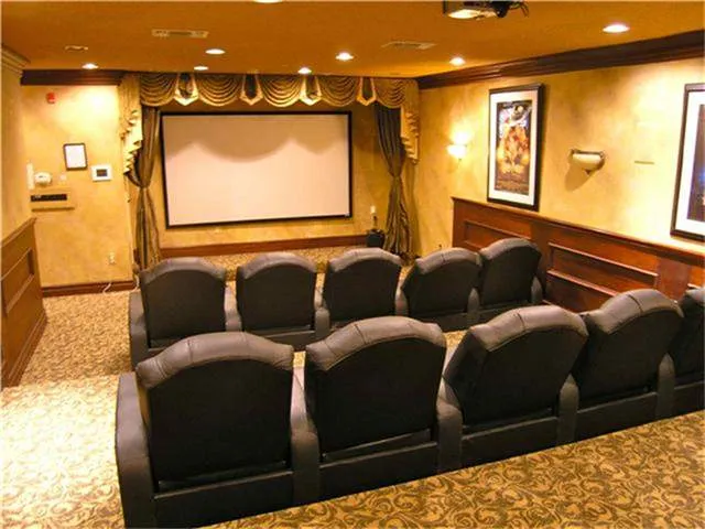 a media room with lots of chairs and a projector screen