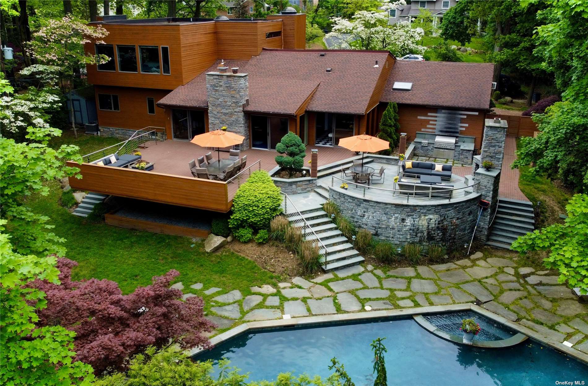 an aerial view of a house with swimming pool garden and outdoor seating