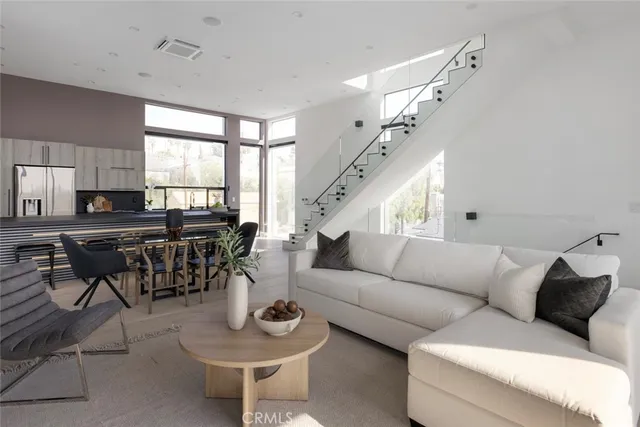 a view of a balcony with wooden floor and bench and floor to ceiling window