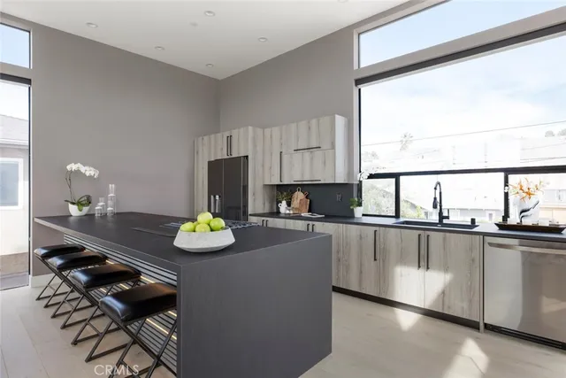 a kitchen with stainless steel appliances granite countertop a sink stove and cabinets