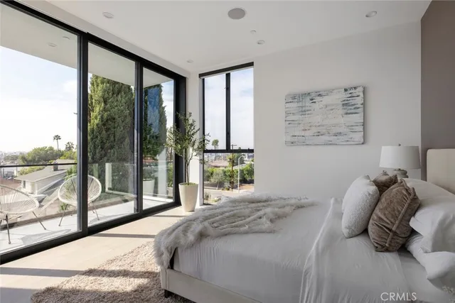 a bedroom with a bed and glass walk in closet