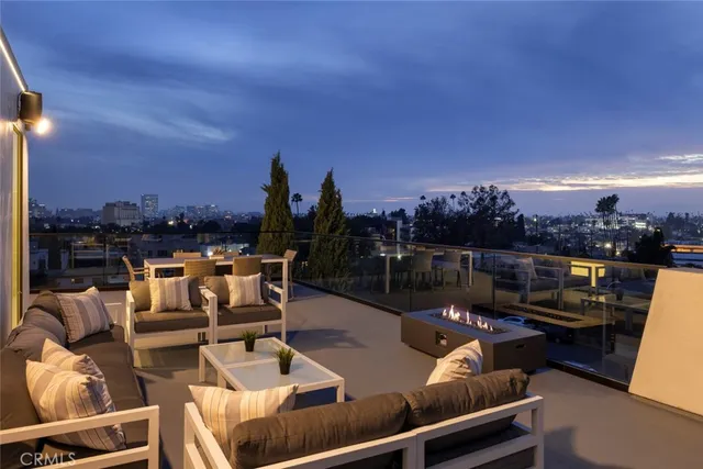 a view of a terrace with lawn chairs