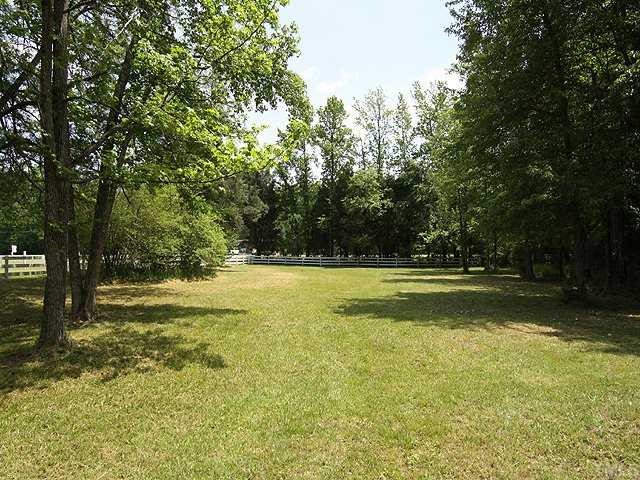 5290 Hurdle Mills Road Roxboro, NC 27574 - Photo 15 of 25 Smaller stable's pasture. Access to the back acreage is to the side of the larger barn.
