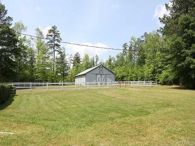 5290 Hurdle Mills Road Roxboro, NC 27574 - Photo 16 of 25 The larger barn has 5 stalls, wash bay, tack room, loft to hold 700 bales, and its own fenced paddock. Behind it lies an additional 12-13 fenced acres.