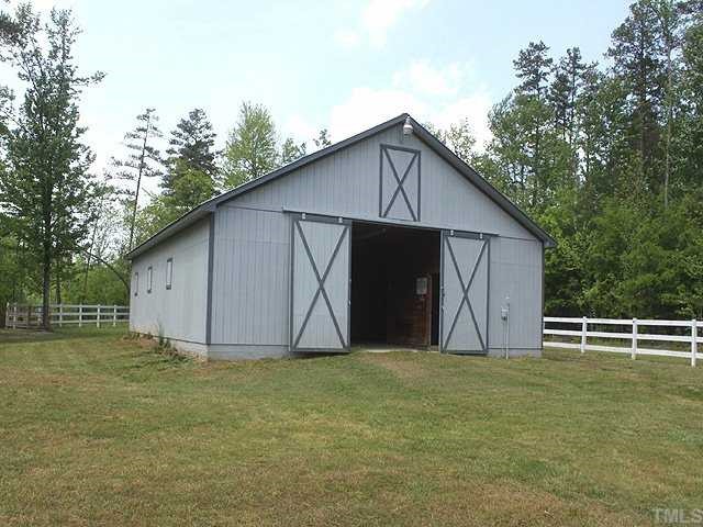 5290 Hurdle Mills Road Roxboro, NC 27574 - Photo 17 of 25 Access to the back acreage is to the right of the fencing.