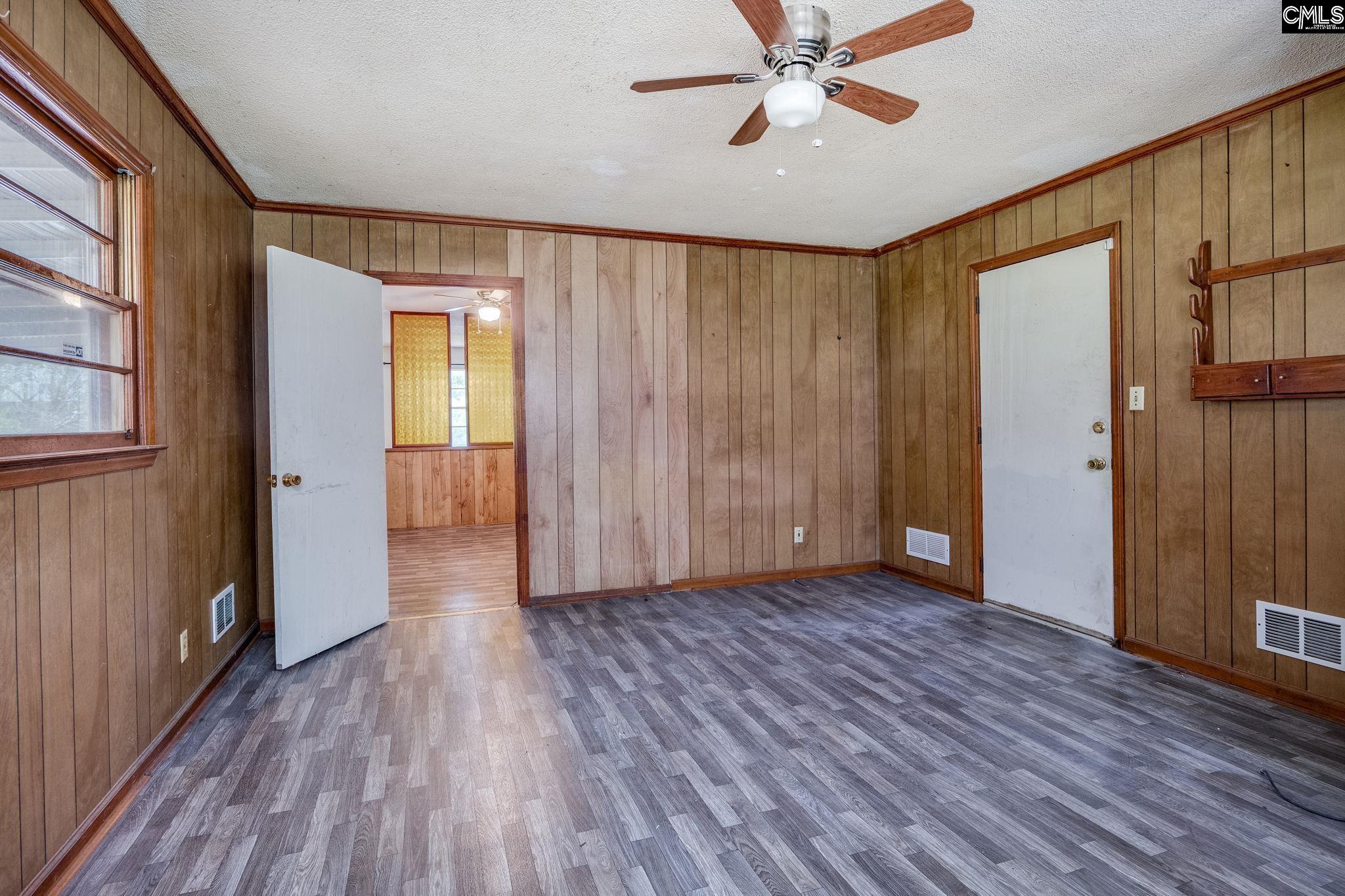 5666 Middleton Court Columbia, SC 29203 - Photo 24 of 42 an empty room with wooden floor fan and windows