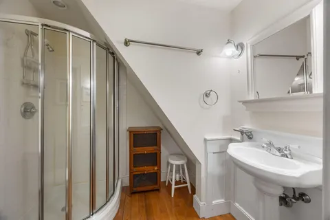 a bathroom with a toilet a sink and a mirror