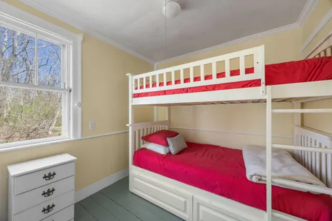 a bedroom with a bed and a table in it