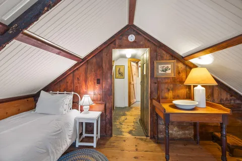 a bedroom with a bed and a fireplace